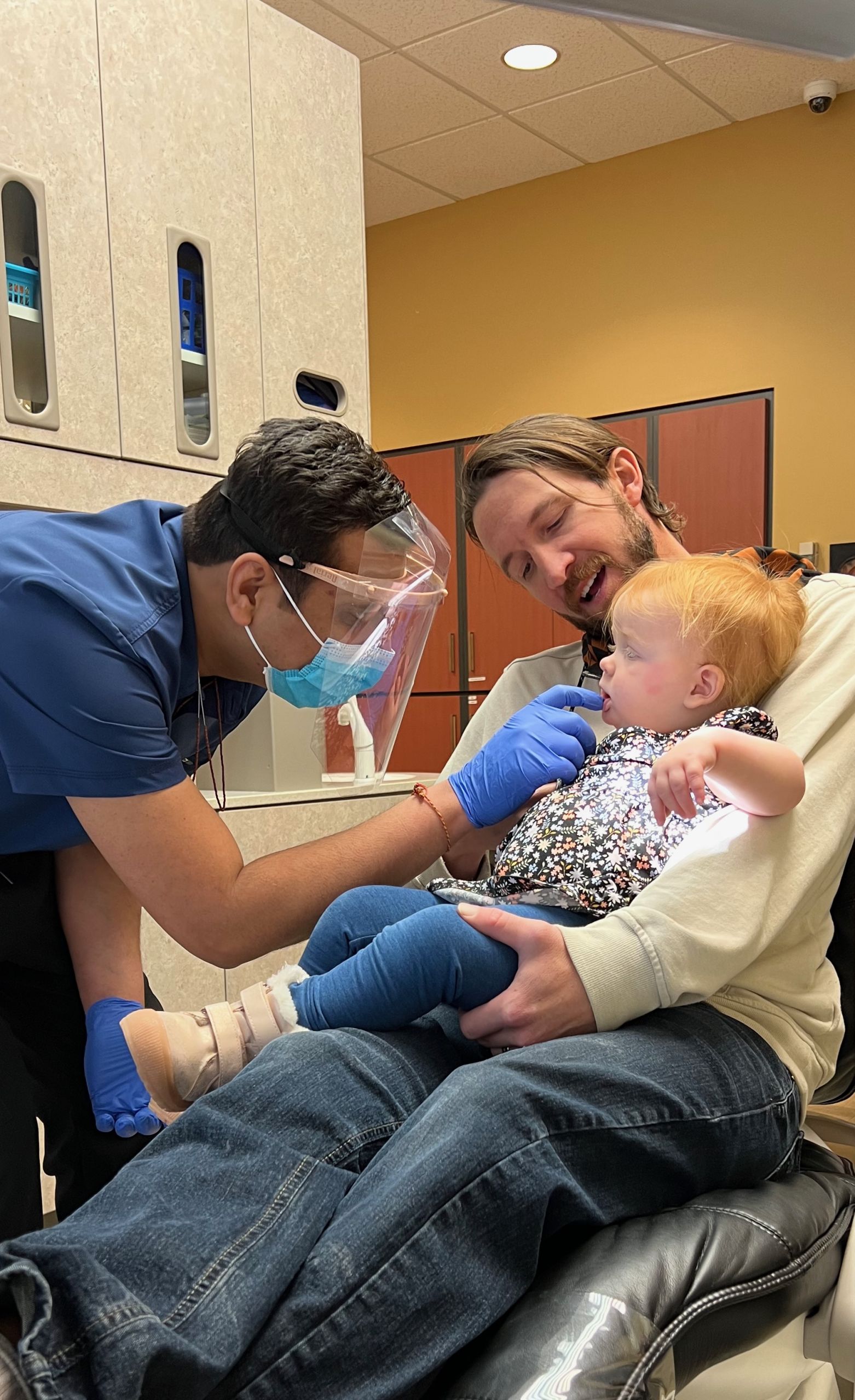 Dr. Patel checking teeth on a child